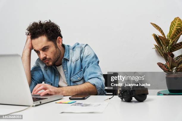 tired and stressed businessman working with a laptop at home. - concerned laptop stock pictures, royalty-free photos & images