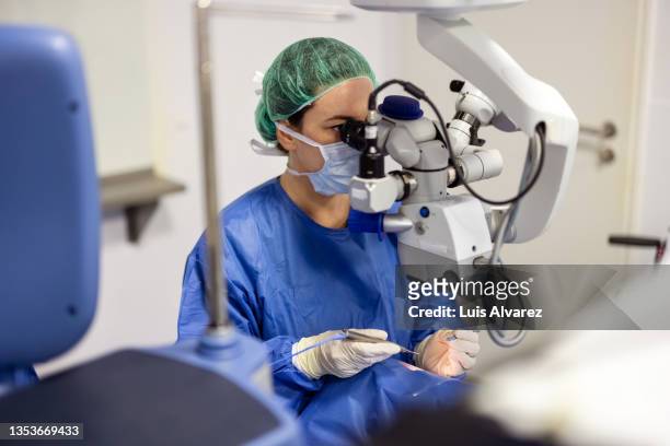 doctor doing eye surgery of patient under microscope - cataract eye stock pictures, royalty-free photos & images