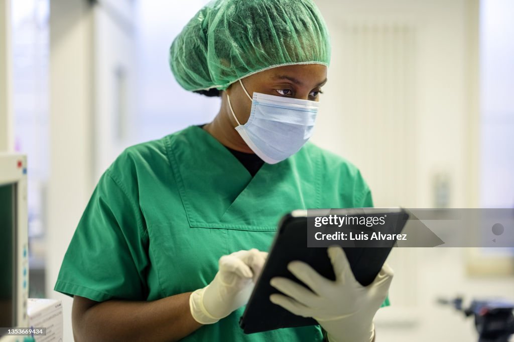 Woman nurse using digital tablet in operating room at eye hospital