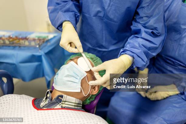close-up of a man patient having eye surgery at hospital - bandage stock pictures, royalty-free photos & images