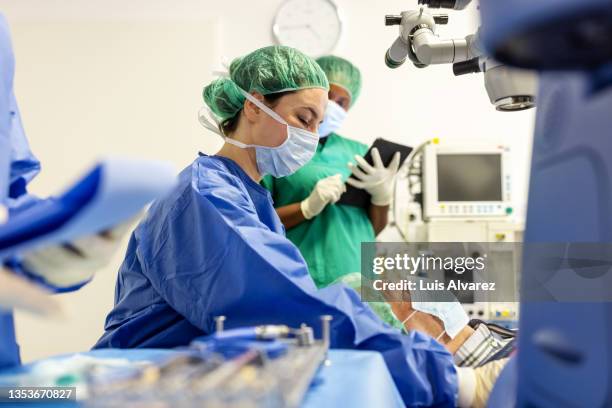 ophthalmologist doing cataract surgery on a patient in eye clinic - infectious disease prevention stock pictures, royalty-free photos & images