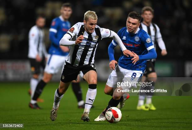 Frank Vincent of Notts County makes a break past Aaron Morley of Rochdale during the Emirates FA Cup First Round Replay match between Notts County...