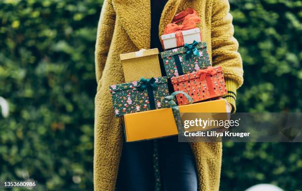woman holding christmas gifts. - regalo di natale foto e immagini stock