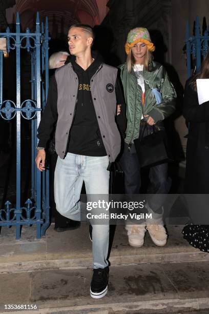 Romeo Beckham and Mia Regan seen leaving the opening party of Skate at Somerset House at Somerset House on November 16, 2021 in London, England.