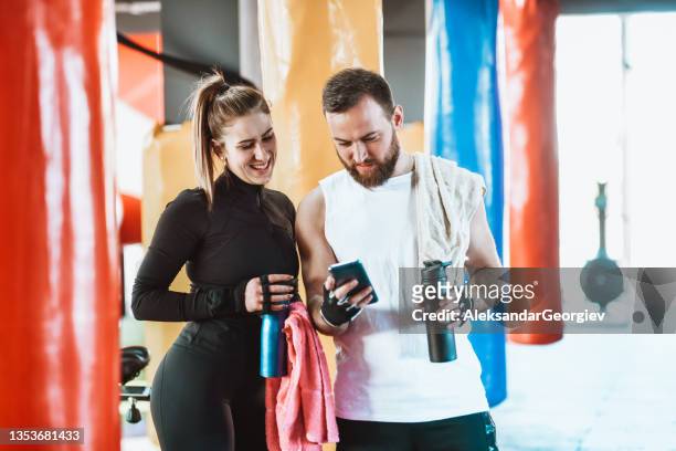 smiling male and female athletes flirting after exercise class - flirting gym stock pictures, royalty-free photos & images
