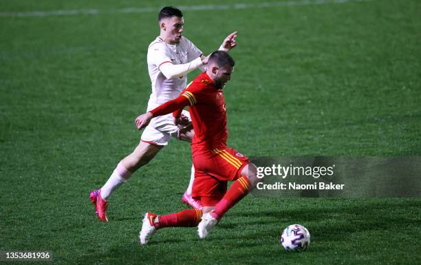 Filip Stojilkovic of Switzerland battles for possession with Brandon Cooper of Walesduring the UEFA European Under-21 Championship Qualifier between...