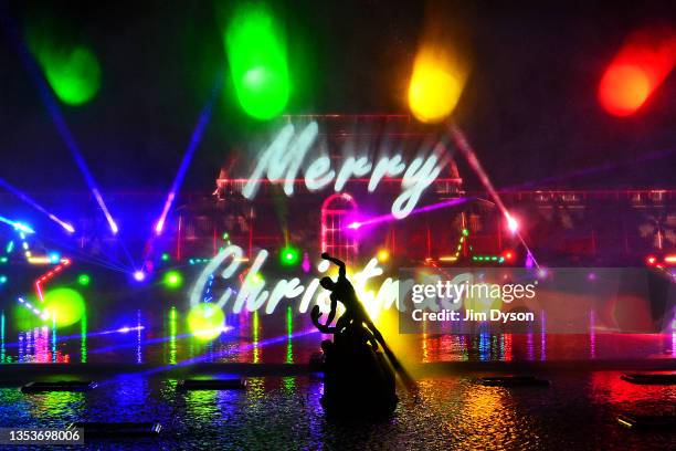 The Palm House at Kew Gardens is illuminated with a light show during a preview for the Christmas at Kew event on November 16, 2021 in London,...