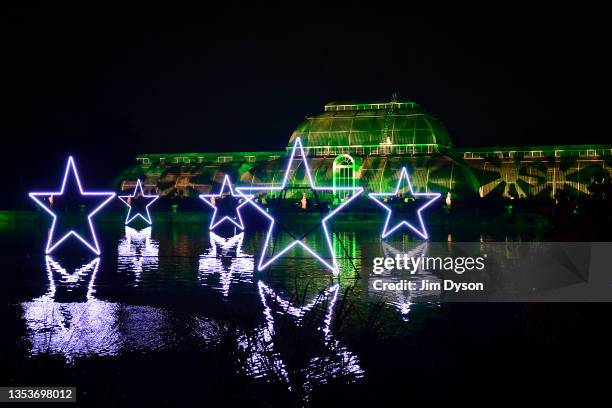 The Palm House at Kew Gardens is illuminated with a light show during a preview for the Christmas at Kew event on November 16, 2021 in London,...