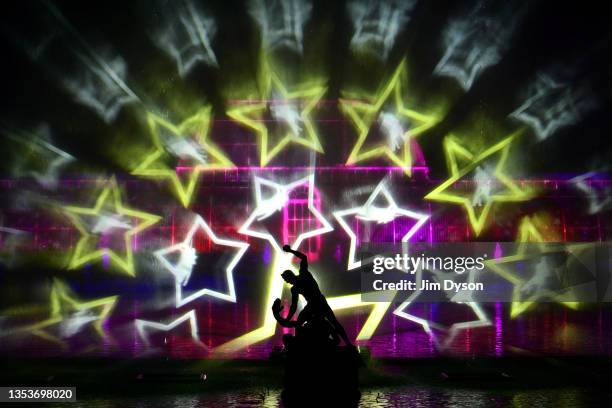 The Palm House at Kew Gardens is illuminated with a light show during a preview for the Christmas at Kew event on November 16, 2021 in London,...