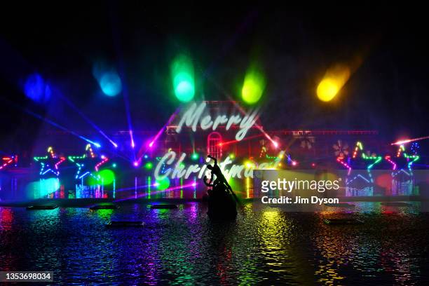The Palm House at Kew Gardens is illuminated with a light show during a preview for the Christmas at Kew event on November 16, 2021 in London,...