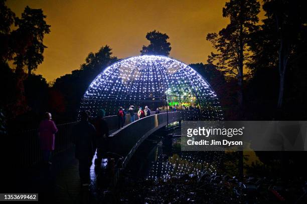 Visitors follow an illuminated trail during a preview for the Christmas at Kew event at Kew Gardens on November 16, 2021 in London, England.
