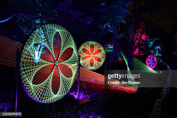 Visitors follow an illuminated trail during a preview for the Christmas at Kew event at Kew Gardens on November 16, 2021 in London, England.