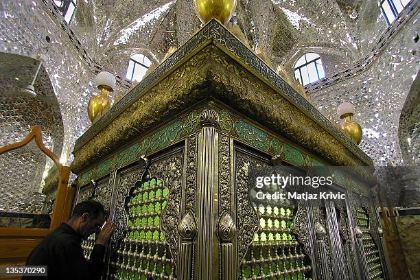 Iranian man is praying by the Tomb of prophet Daniel on June 25, 2005 in Susa, Iran.