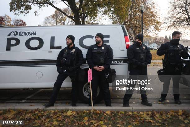 Police keep watch as demonstrators gather outside of the Kenosha County Courthouse as the jury deliberates in the trial of Kyle Rittenhouse on...