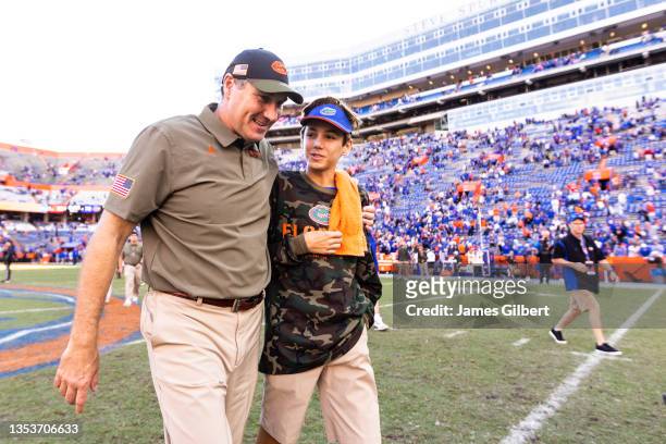 Head coach Dan Mullen of the Florida Gators looks on with his son Canon Mullen after defeating the Samford Bulldogs 70-52 in a game at Ben Hill...