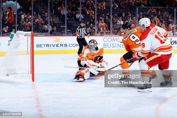 Carter Hart of the Philadelphia Flyers watches the puck go into the net for a goal by Oliver Kylington of the Calgary Flames during the first period...