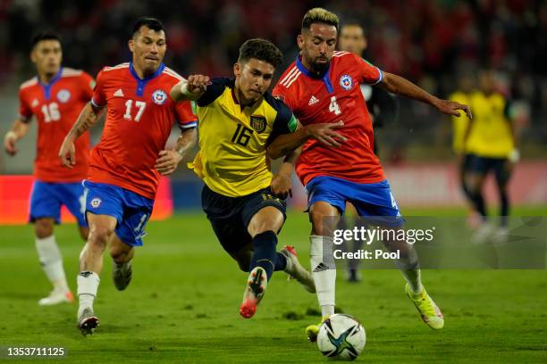 Jeremy Sarmiento of Ecuador and Mauricio Isla of Chile fight for the ball during a match between Chile and Ecuador as part of FIFA World Cup Qatar...