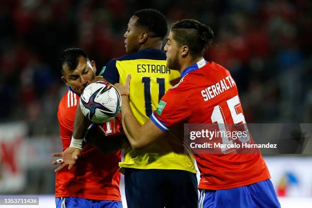 Gary Medel and Francisco Sierralta of Chile fight for the ball with Michael Estrada of Ecuador during a match between Chile and Ecuador as part of...