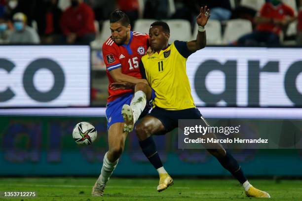 Michael Estrada of Ecuador and Francisco Sierralta of Chile fight for the ball during a match between Chile and Ecuador as part of FIFA World Cup...