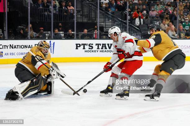 Robin Lehner of the Vegas Golden Knights blocks a shot by Seth Jarvis of the Carolina Hurricanes as Nicolas Hague of the Golden Knights defends in...