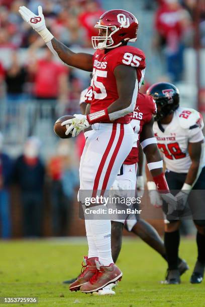 Defensive end Isaiah Thomas of the Oklahoma Sooners celebrates after knocking the ball out of the throwing hand of quarterback Donovan Smith of the...