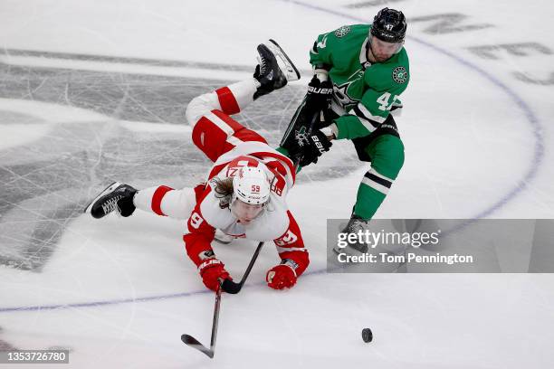 Tyler Bertuzzi of the Detroit Red Wings battles for the puck against Alexander Radulov of the Dallas Stars in the third period at American Airlines...