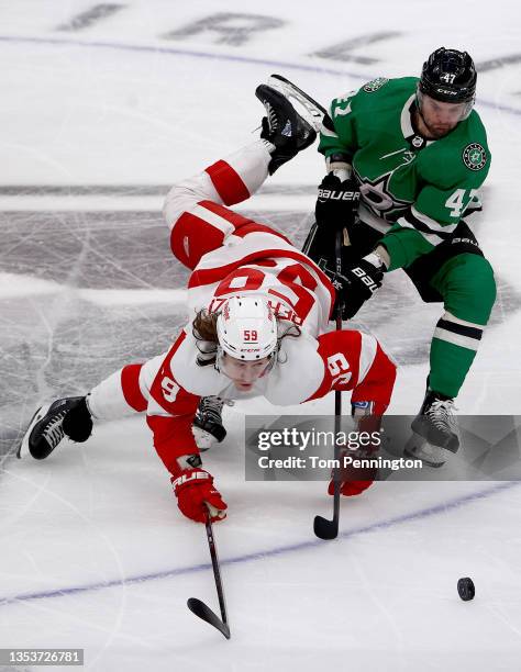 Tyler Bertuzzi of the Detroit Red Wings battles for the puck against Alexander Radulov of the Dallas Stars in the third period at American Airlines...