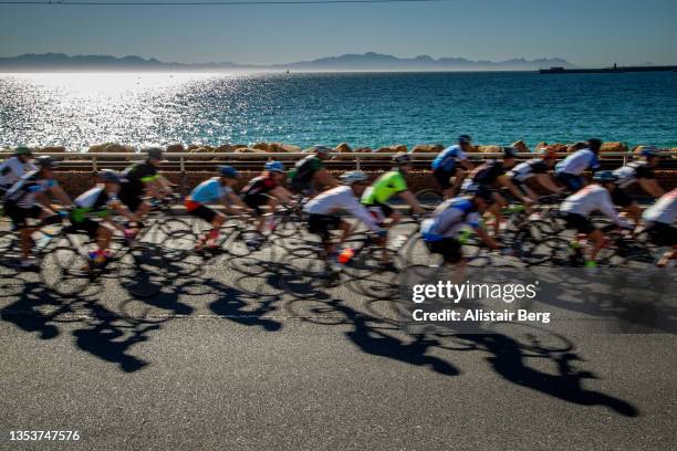 group of blurred riders in a mass participation cycle race - cycling event stock pictures, royalty-free photos & images