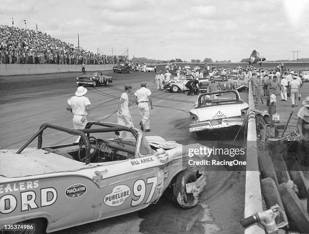 May 12, 1957: Bill Amick’s Ford rests against the inside front stretch wall of Darlington Raceway after a multi-car crash on lap 29 of the Rebel 300,...