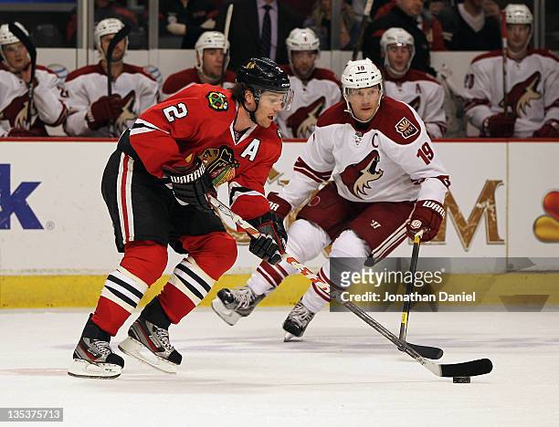 Duncan Keith of the Chicago Blackhawks controls the puck under pressure from Shane Doan of the Phoenix Coyotes at the United Center on December 5,...