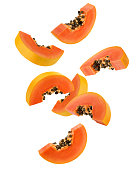Falling papaya slice isolated on white background, clipping path, full depth of field