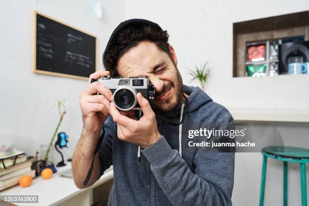 front view of photographer looking through the lens of his professional camera. - man facing camera stock pictures, royalty-free photos & images