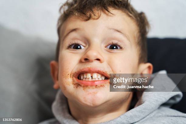 close-up view of beautiful child smiling at the camera with messy face. - chocolate face stock pictures, royalty-free photos & images
