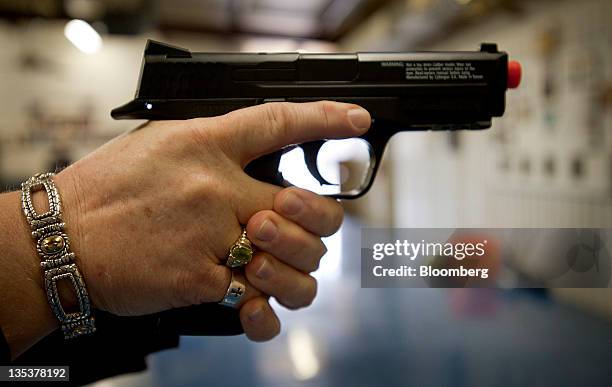 Tammy Pinkston, founder and instructor of Oklahoma Personal Defense Academy, demonstrates target practice with an Airsoft gun before an all women...