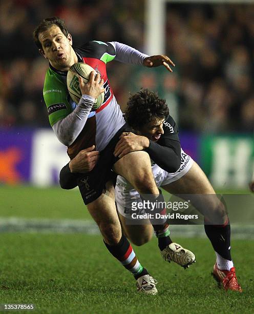 Benjamin Urdapilleta of Harlequins is tackled by Yannick Jauzion during the Heineken Cup match between Harlequins and Toulouse at Twickenham Stoop on...
