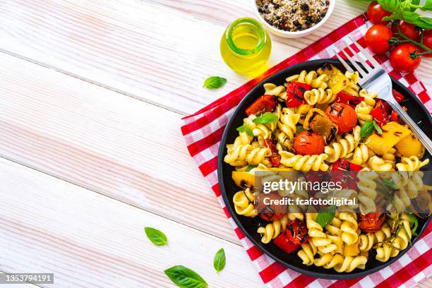 vegan pasta salad plate on white table. copy space - primavera stock pictures, royalty-free photos & images