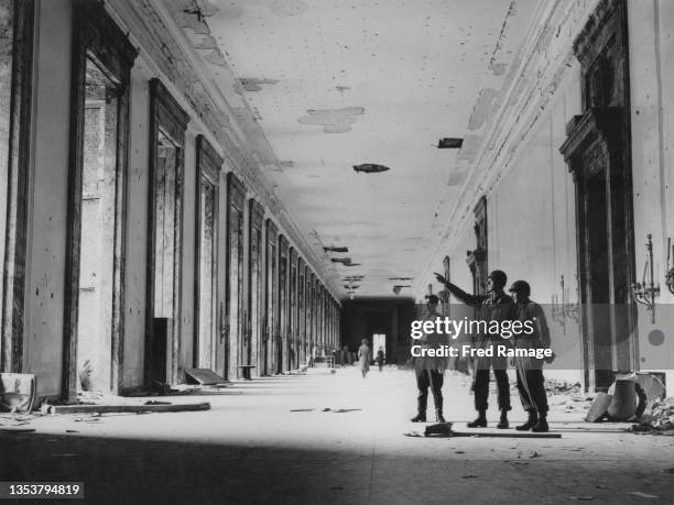 American and Soviet Red Army officers tour the bomb damaged Great Hall of Adolf Hitler's Third Reich Chancellery building on 23rd May 1945 in Berlin,...