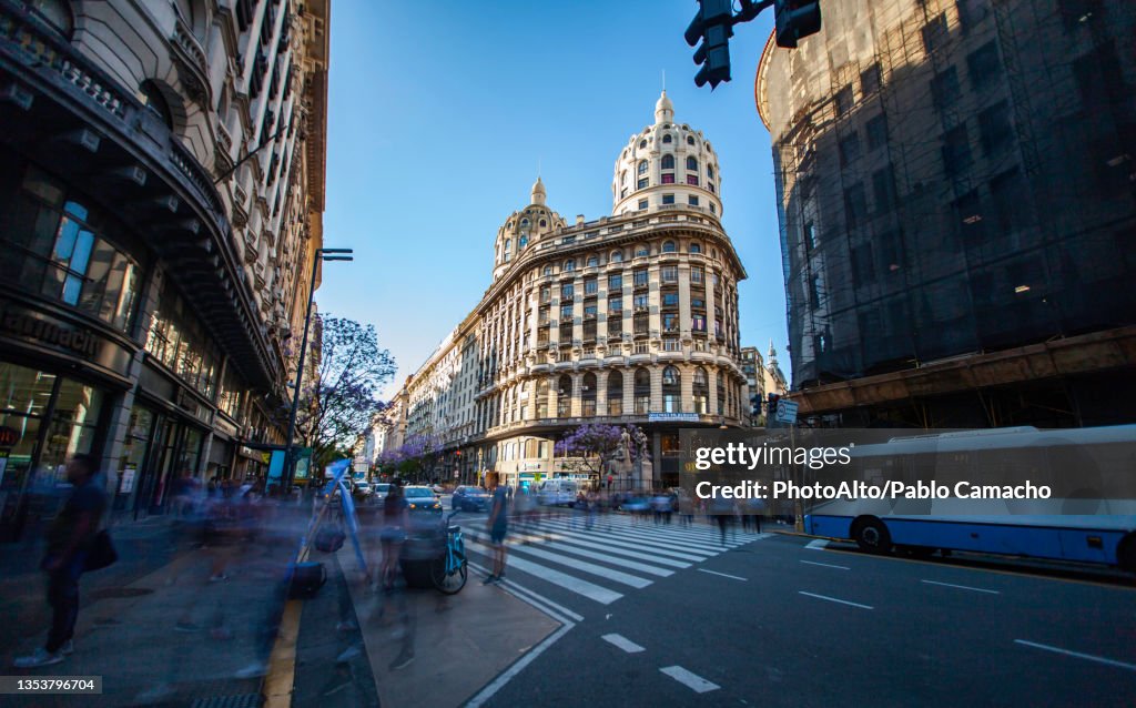 View of traffic and pedestrian on street with Eclectic Bencich Building in background