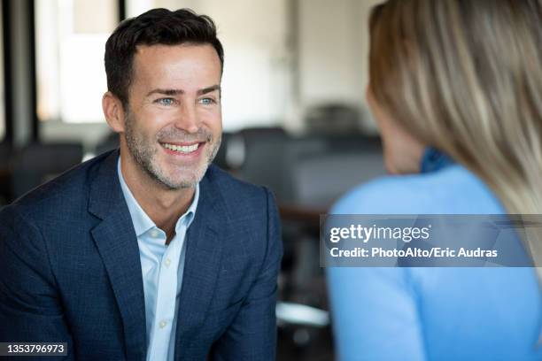 smiling businessman talking to his colleague - planalto stock pictures, royalty-free photos & images