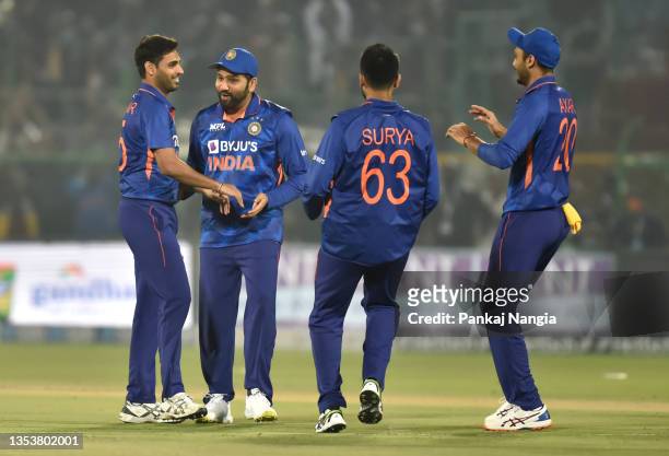 Bhuvneshwar Kumar of India celebrates the wicket of Daryl Mitchell of New Zealand with teammates during the T20 International Match between India and...