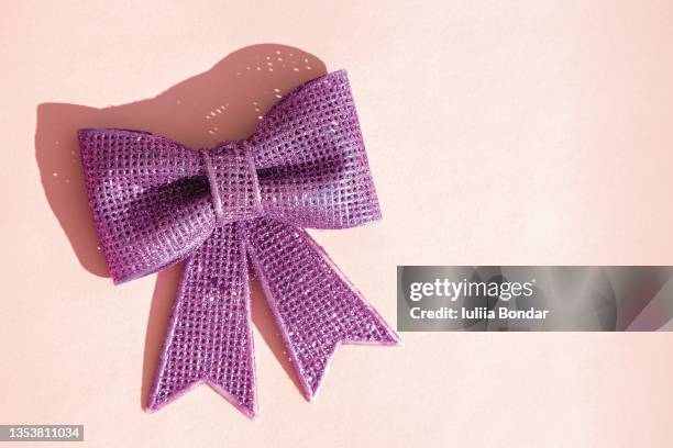 purple bow on pink background - hair bow stock pictures, royalty-free photos & images