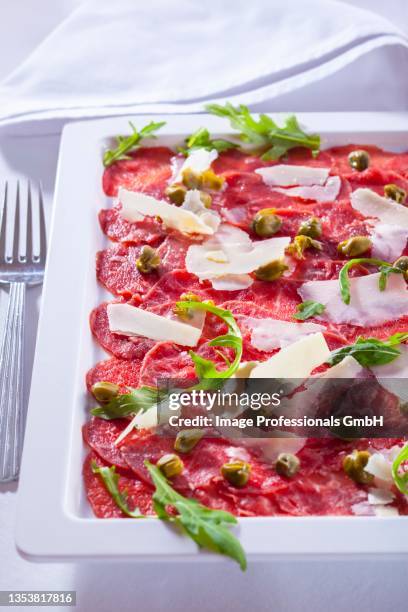 carpaccio (slices of raw beef with capers and parmesan cheese, italy) - shaved parmesan cheese stock pictures, royalty-free photos & images