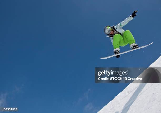 snowboarder midair in halfpipe - half pipe stock pictures, royalty-free photos & images