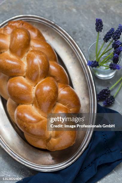 a yeast plait on a metal tray - braided bread stock pictures, royalty-free photos & images