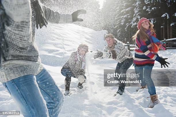 austria, salzburg country, flachau, young people snow fighting in snow - bola de neve imagens e fotografias de stock