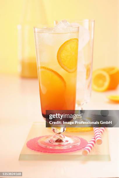 an orange sunrise with ice cubes - tequila sunrise stock pictures, royalty-free photos & images