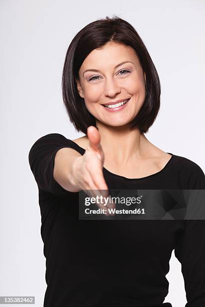 mid adult woman greeting against white background, smiling, portrait - handshake isolated stock pictures, royalty-free photos & images