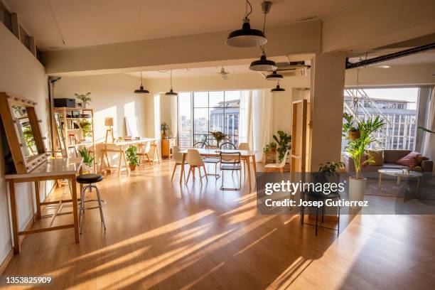 loft open space style studio. sunny day through two windows. urban landscape - living room floor stock pictures, royalty-free photos & images