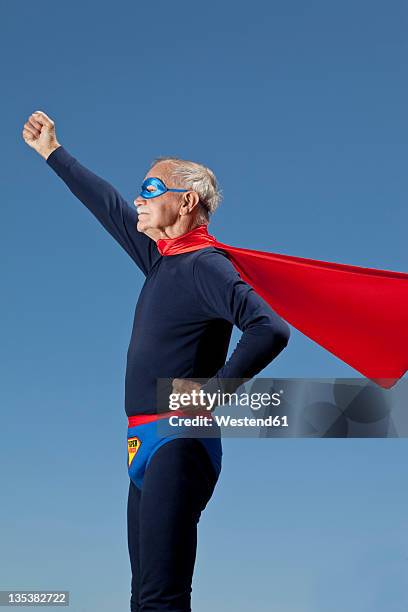 austria, burgenland, senior man in superman's costume - superman superhero stock pictures, royalty-free photos & images