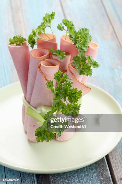 close up of leberkaese slices rolled up, tied and garnished with parsley - leberkäse stock pictures, royalty-free photos & images